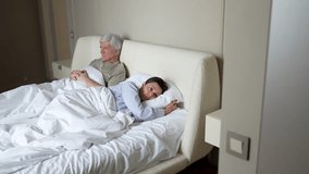 Argument and break up in family. Man lies in bed, trying to reconcile with wife, but wife turns away hurt by betrayal. Infidelity, relationship strain, deception, emotional disconnect, divorce looming - Powered by Shutterstock - Get 15% off with code: PIKWIZARD15