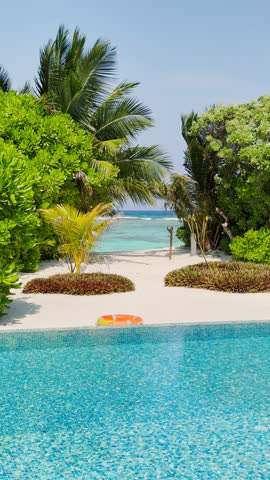 A private beach in the courtyard of a huge luxury villa with a private pool and water slide on a clear sunny day, a paradise for relaxation and vacation