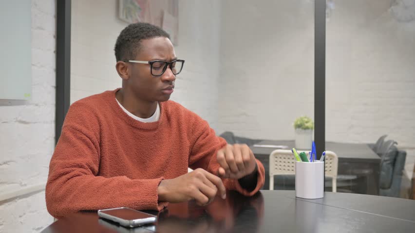 African American Man Leaving Workspace, Getting Late for Meeting