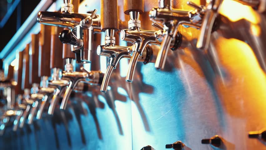 Close-up of beer taps moving horizontal footage