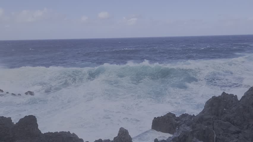 Strong sea wave hitting the rocks. Beutiful blue Sea. Porto Moniz, Madeira Island. Portugal.