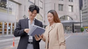 Asian young businessman and woman partner working outdoors in city. Attractive colleagues employee people feel happy and relax while spend free leisure time standing outside office company together. - Powered by Shutterstock - Get 15% off with code: PIKWIZARD15