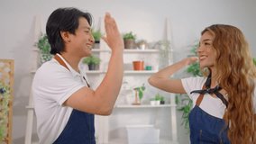 Portrait of Asian young couple caring for plants together in tree shop. Attractive small business man and woman owners feeling happy and relax while managing plant store, arranging trees for customer. - Powered by Shutterstock - Get 15% off with code: PIKWIZARD15