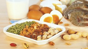 A variety of protein-rich foods including nuts, eggs, and dairy are displayed against a blue background with natural lighting - Powered by Shutterstock - Get 15% off with code: PIKWIZARD15