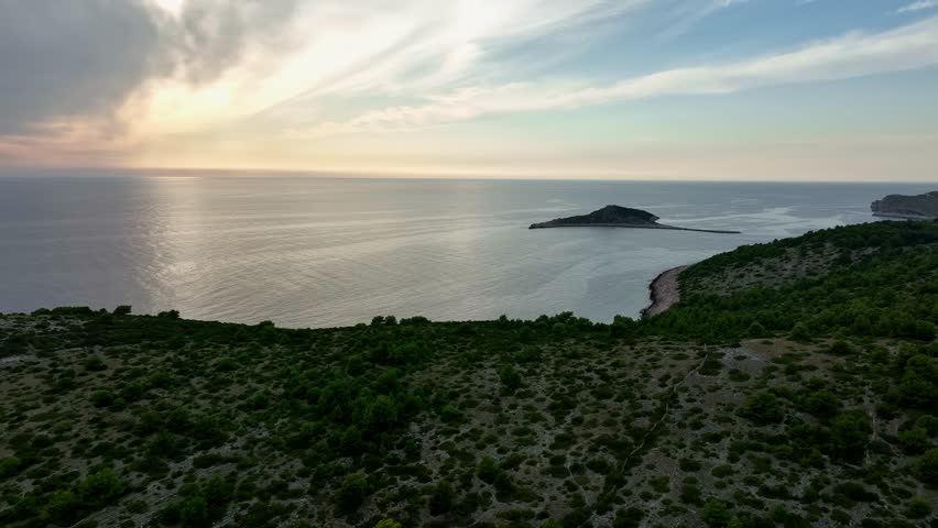 Aerial: sunset over Kornati Bay with landscape and the Mediterranean Sea in Dalmatia, Croatia, establishing drone shot