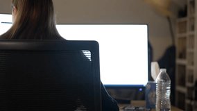 Businesswoman Working on Dual Monitors in Office, Rear View - Powered by Shutterstock - Get 15% off with code: PIKWIZARD15