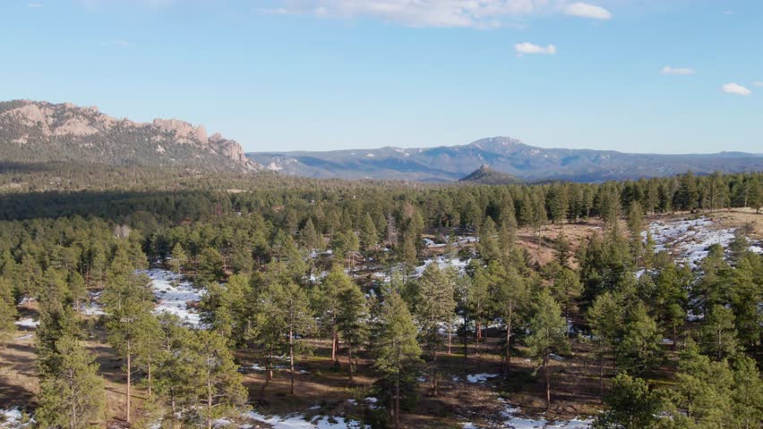 Aerial drone view of the Pike National Forest and Long Scraggy Mountain. Forward dolly with left pan. Filmed in the Rocky Mountains of Colorado.