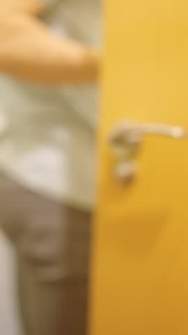 Man opening and closing bathroom door