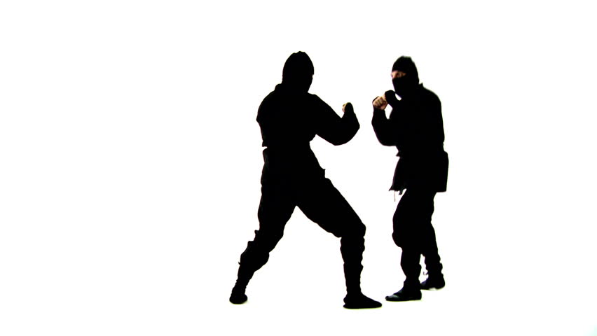 Masked ninjas fight hand to hand. Hand held camera in a white studio.