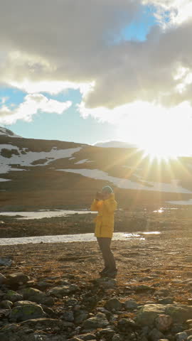 Aurlandsfjellet, Norway - June 13, 2019: Young Woman Tourist Traveler Photographer Taking Pictures Photos Near Parked Renault Duster Car. Aurlandsfjellet Scenic Route Road.