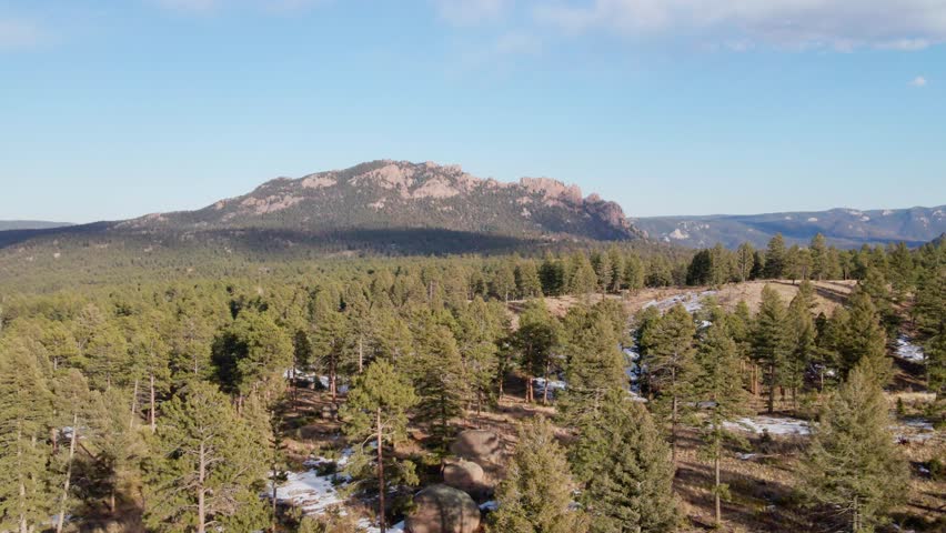 Aerial drone view of the Pike National Forest and Long Scraggy Mountain. Trucking movement to the left. Filmed in the Rocky Mountains of Colorado.