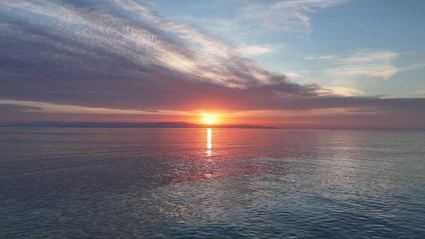 Aerial view of sunset horizon over the sea with Zakynthos island in the background in Greece