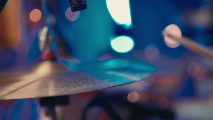 Closeup view of cymbals of drum kit in musical studio, drummer beating rhythm. Drumsticks in hands of talented rock musician, contemporary music and art, gig of trendy rock band on stage in nightclub