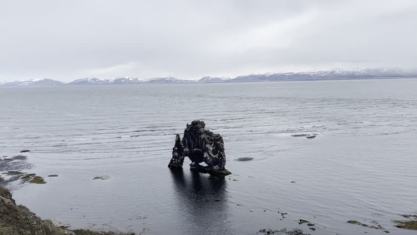 Sea stack landmark Iceland waves crashing and breaking in Iceland ocean 4k hdr
