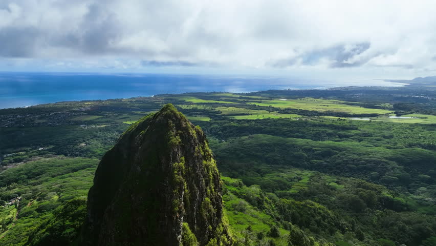 Drone flying near to the sunlit Kalalea King Kong mountain, in Kauai, Hawaii