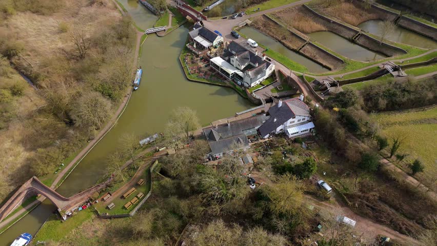 Aerial view drone perspective of Lock system inland navigation river boats in England. Victorian era navigation system green sunny England.