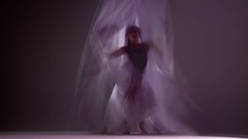 Gymnastic young woman dances with silks. Montage clip created with long shutter