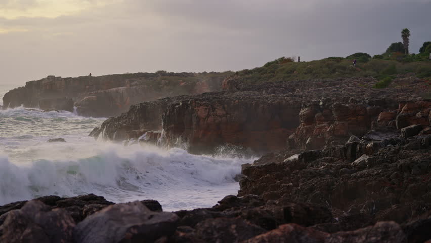 Waves breaking over dangerous rocks. Awesome power of waves breaking over dangerous rocks, breaking up into tiny drops