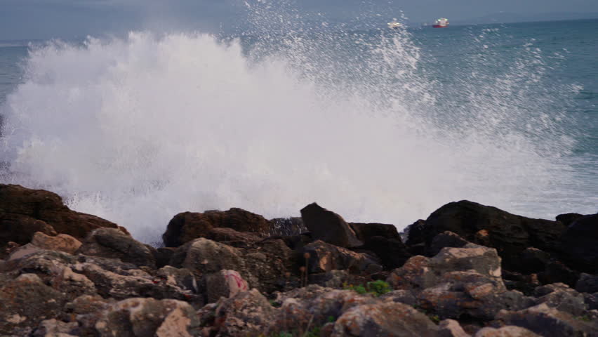 Waves breaking over dangerous rocks. Awesome power of waves breaking over dangerous rocks 