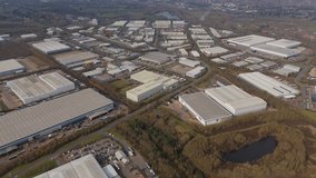 Aerial drone high up warehouse district industrial park businesses in England East Midland. Grey skies data centres quantum computing and logistics. - Powered by Shutterstock - Get 15% off with code: PIKWIZARD15