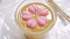 Gel candle with pink wax hearts in decorative glass cup for cozy ambiance - Powered by Shutterstock - Get 15% off with code: PIKWIZARD15