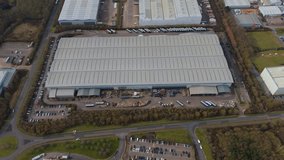 Aerial drone high up warehouse district industrial park businesses in England East Midland. Grey skies data centres quantum computing and logistics. - Powered by Shutterstock - Get 15% off with code: PIKWIZARD15