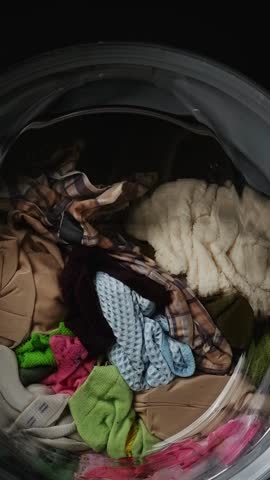 Laundry rotating inside washing machine drum