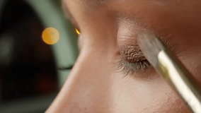 Makeup artist carefully blending eyeshadow, showcasing professional beauty technique through precise brush application in detailed close-up view - Powered by Shutterstock - Get 15% off with code: PIKWIZARD15