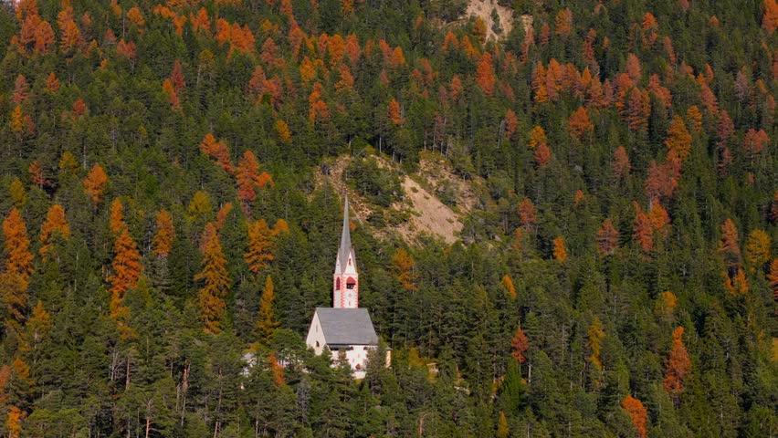 Church of St. Jacob with mountains in the background. Italy
