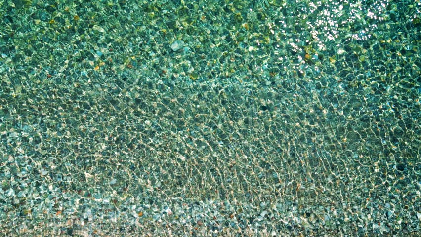 Top-down view of sea azure waves pattern and crystal clear water. Rhodes, Greece