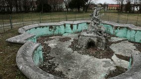 Abandoned fountain near woods
