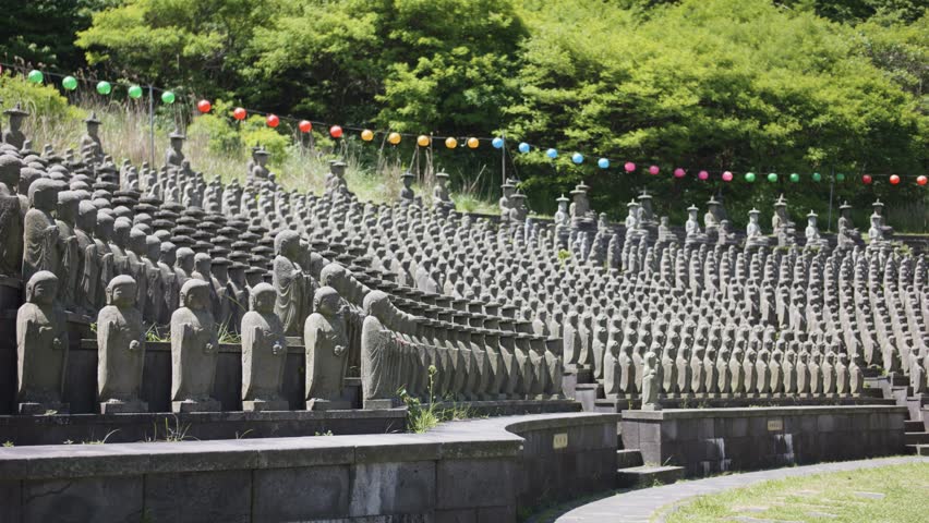 View of hundreds of stone Buddha statues at Gwaneumsa Temple on Jeju Island, South Korea, showcasing spiritual and cultural heritage. Perfect for travel, religious, or cultural visuals, 4K and 50 fps