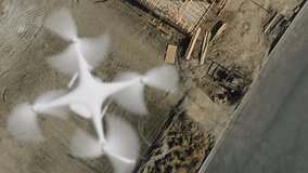 Aerial Angle Above A UAV Quadcopter Drone Flying Slow Motion Outdoors Above A Housing Construction Site. - Powered by Shutterstock - Get 15% off with code: PIKWIZARD15