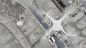 Aerial Angle Above A UAV Quadcopter Drone Flying Slow Motion Outdoors Above A Housing Construction Site. - Powered by Shutterstock - Get 15% off with code: PIKWIZARD15