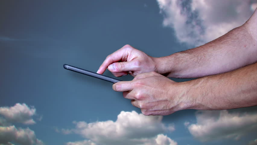 A man uses a tablet PC connected to The Cloud.