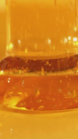 Slow motion of dripping honey. 8K downscale, filmed on high speed cinema camera. Slow motion, 4K.
