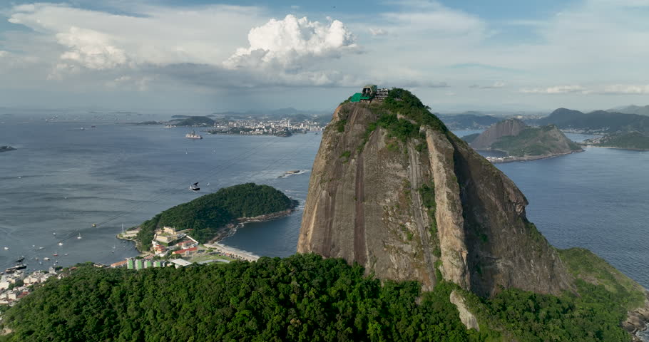 Aerial shot of two cable cars passing each other on the way to Sugar Loaf Mountain in Rio de Janeiro