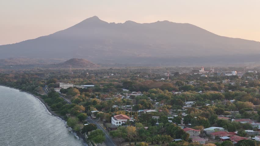 Stunning landscape showcases mountains, serene waterfront, and lush greenery in Nicaragua during dusk light.