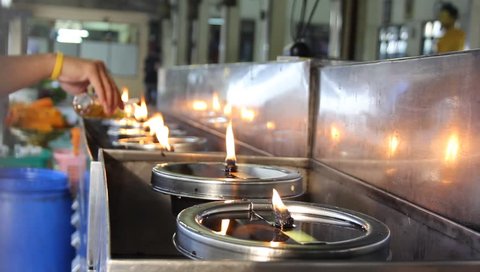 Buddhist fill some oil into oil lamps to get good luck and good long life : film stockowy
