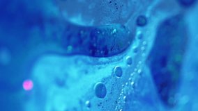 Vertical video. Sparkling fluid. Glitter oil drip. Defocused blue color shiny grain sequin particles water paint liquid pigment emulsion spill motion abstract art background. - Powered by Shutterstock - Get 15% off with code: PIKWIZARD15