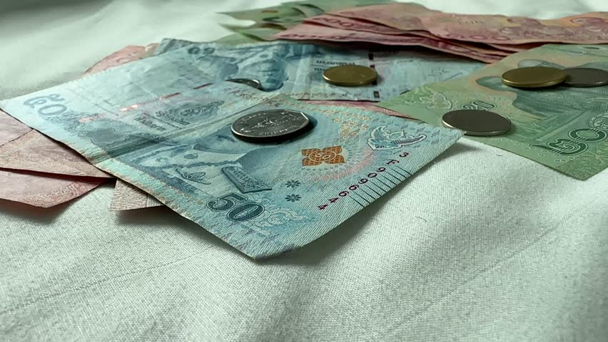 Close up of Thai Baht currency bills notes coins THB Thailand money cash