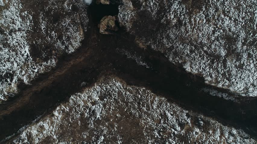 Ukrainian soldiers moving in trenches top view
