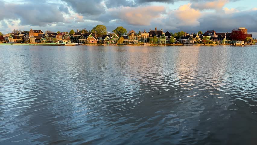 traditional Dutch small town scenery in Zaanse Schans over water at summer sunset, Netherlands
