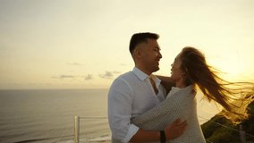 Asian couple meet sunset on the rooftop, loving man and woman together. Honeymoon trip, enjoying sea view from balcony.  - Powered by Shutterstock - Get 15% off with code: PIKWIZARD15