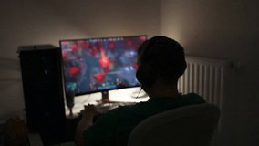 Selective focus on Caucasian gamer using gaming pc professional setup while having fun playing online games at home. Man enjoying relaxing free time streaming multiplayer competition. - Powered by Shutterstock - Get 15% off with code: PIKWIZARD15