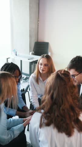 View from the top, closeness. People are in group psychological support room together.