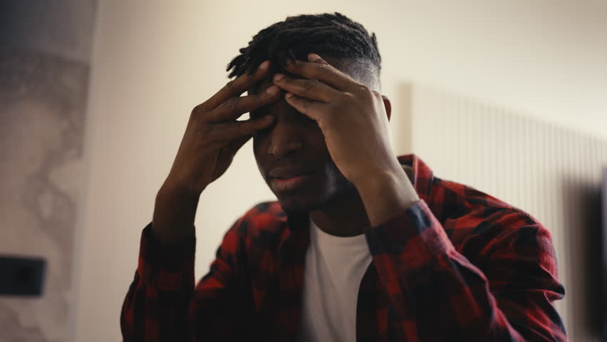 Upset male programmer reading a bad news email, stressed about work problems