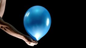 Watch as a blue balloon is held by one hand, while scissors in the other hand slice through the balloon, causing it to pop. This dramatic close-up captures the tension and excitement in slow motion. - Powered by Shutterstock - Get 15% off with code: PIKWIZARD15
