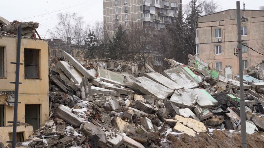 Urban decay: crumbling building ruins and rubble heaps amid existing structures, depicting desolation and abandonment