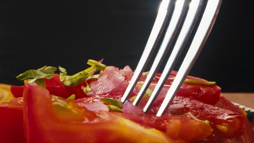 Summer vegan tomato salad with parsley, red onion, garlic, pepper and olive oil dressing, white table background, top view